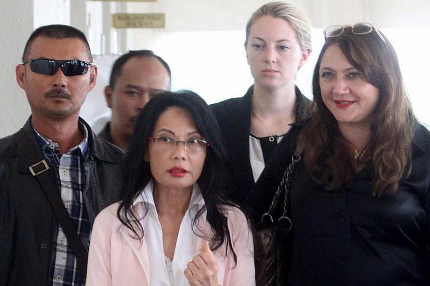Tycoon Khoo Kay Peng has succeeded in establishing his case for the Malaysian court to hear his divorce proceedings against Pauline Chai Siew Phin (centre). -- PHOTO: THE STAR/ASIA NEWS NETWORK&nbsp;