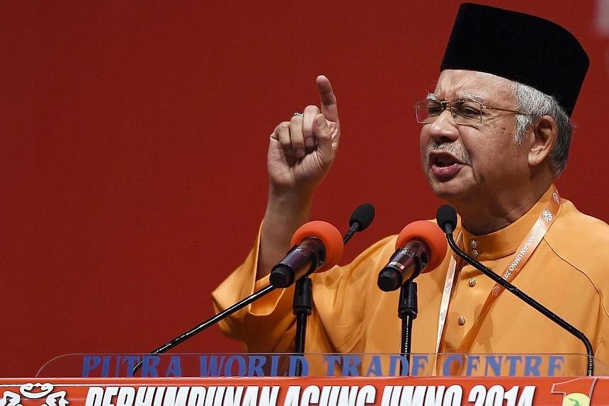 Malaysian Prime Minister Najib Razak addresses delegates during the annual congress of his ruling party, the United Malays National Organisation (UMNO), in Kuala Lumpur on Nov 27, 2014. -- PHOTO: AFP