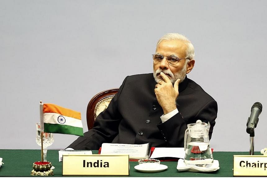India's Prime Minister Narendra Modi looks on during the opening session of the 18th South Asian Association for Regional Cooperation (SAARC) summit in the Nepalese capital Kathmandu on Nov 26, 2014. India pledged a slew of regional investments at a 