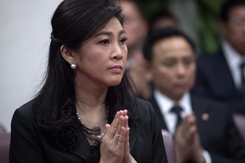 This picture taken on Sept 29, 2014 shows ousted Thai prime minister Yingluck Shinawatra praying during a funeral ceremony inside a Buddhist temple in Bangkok. Jatuporn Prompan.&nbsp;Thailand's military-appointed legislature on Friday started impeach