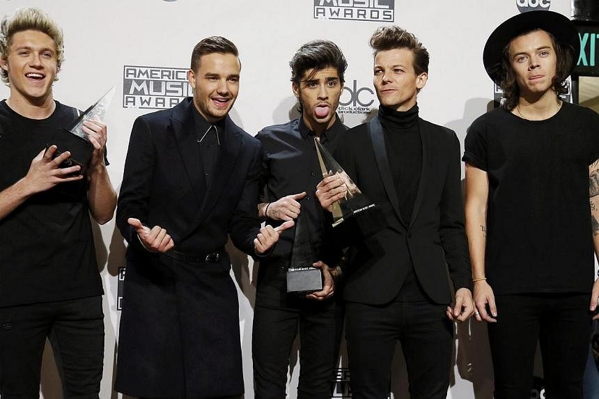 One Direction poses backstage with their awards during the 42nd American Music Awards in Los Angeles, California on Nov 23, 2014. -- PHOTO: REUTERS