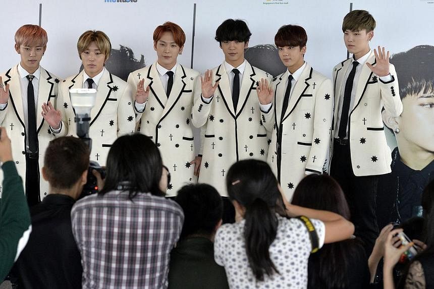 South Korean hip-hop group B.A.P members (from left) Daehyun, Jongup, Himchan, Yongguk, Youngjae and Zelo at a press conference for their concert. -- ST PHOTO: DESMOND FOO