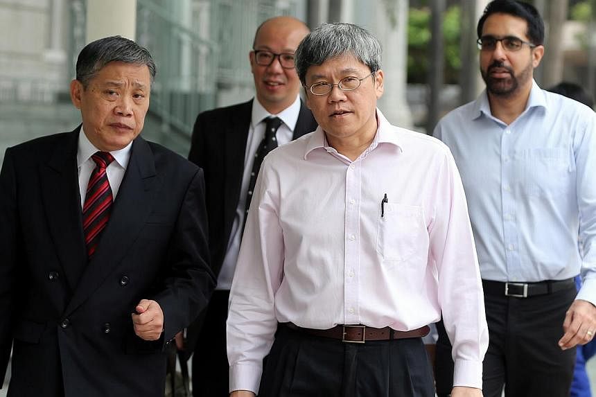 (From left) Defence lawyers Peter Low and Terence Tan with AHPETC vice-chairmen Png Eng Huat and Pritam Singh on Nov 28, 2014. -- ST PHOTO: WONG KWAI CHOW