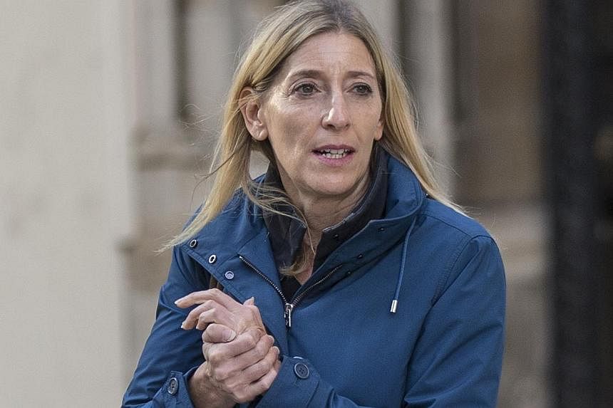 Jamie Cooper, the estranged wife of billionaire hedge fund manager Chris Hohn, leaves the High Court after a divorce hearing, in central London in this Oct 10, 2014 file photo. -- PHOTO: REUTERS