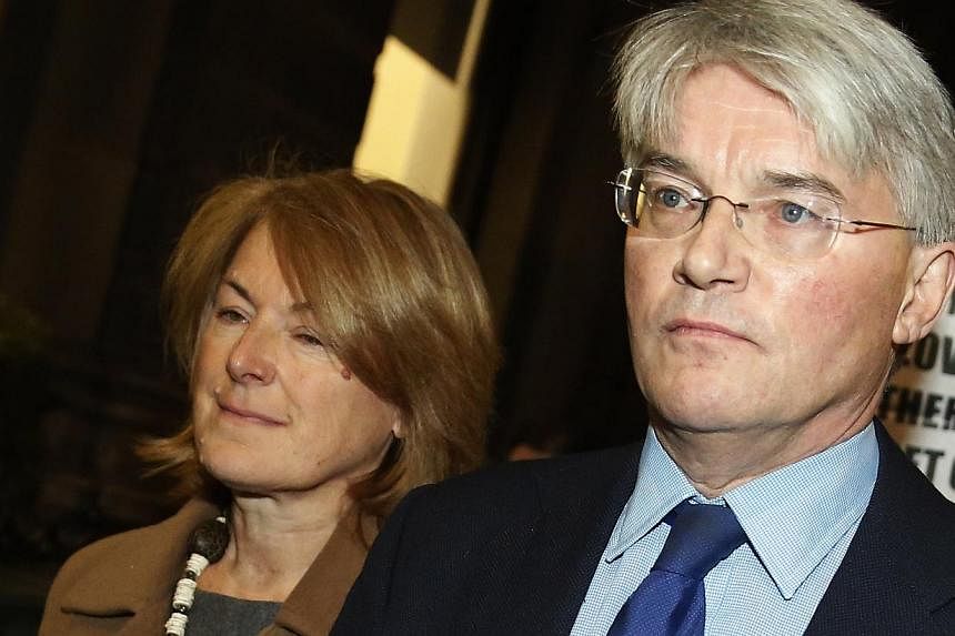 Andrew Mitchell, Britain's former Conservative Party chief whip, leaves the Royal Courts of Justice with wife Sharon Bennett in London, Nov 27, 2014. Mitchell lost a libel case on Thursday over a newspaper article which said he had insultingly referr
