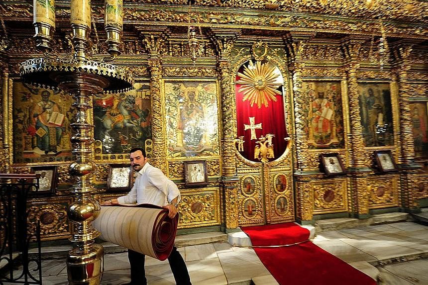 Staff of St. George Church in Fener Patriarchate on Nov 27, 2014, preparing for Pope Francis' visit to Istanbul. He will be in Turkey from Nov 28 to 30. -- PHOTO: AFP