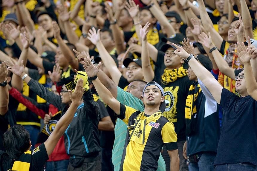 Malaysia fans at the National Stadium in Singapore during the AFF Suzuki 2014 Cup on Nov 29, 2014. &nbsp;-- ST PHOTO: LIM SIN THAI