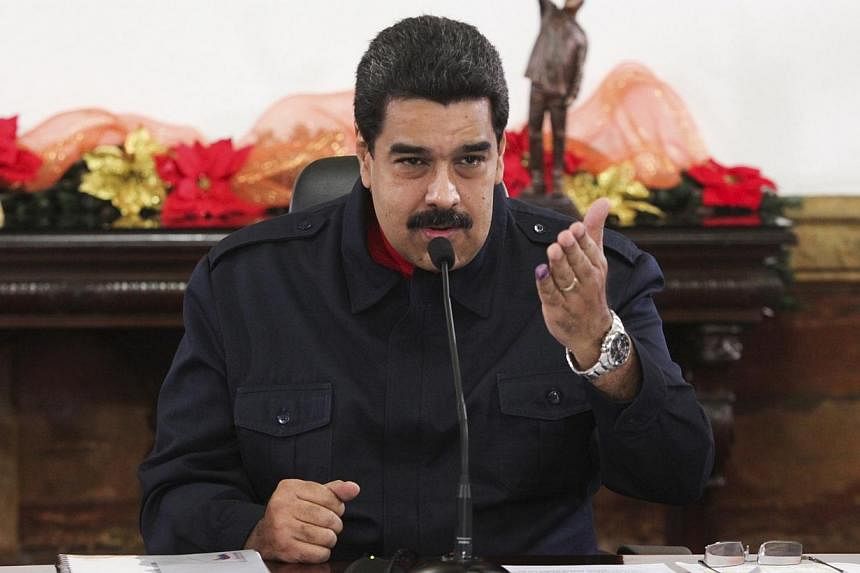 Venezuelan President Nicolas Maduro ordered his government on Friday to slash the budget of his oil-dependent and economically-weak nation, as crude prices plunge after Opec held output steady. -- PHOTO: REUTERS