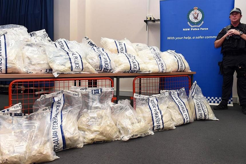 An Australian Federal Police officer stands guard over some of the seized drugs in one of the largest drug busts in the country's history. -- PHOTO: AFP