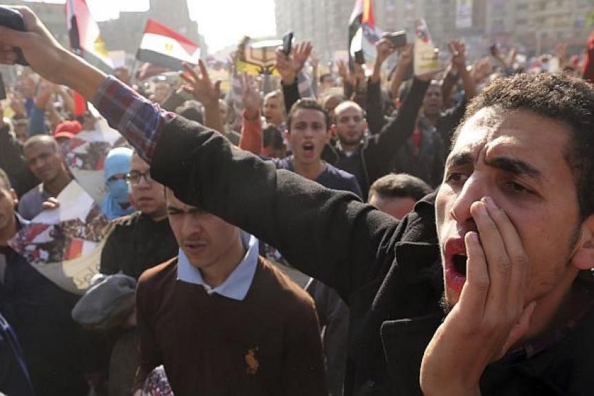 Supporters of the Muslim Brotherhood and ousted Egyptian President Mohamed Morsi shout slogans against the military and the interior ministry during a protest in Cairo Nov 28, 2014.&nbsp;Two people were killed on Friday when Islamist protesters and p