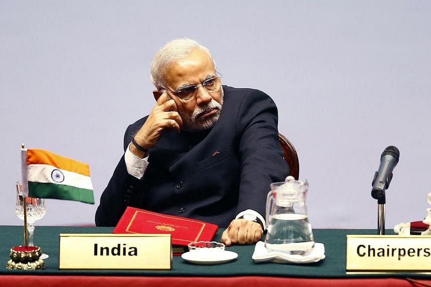 In this photograph taken on Novr 26, 2014, the Prime Minister of India Narendra Modi looks on during the opening session of the 18th South Asian Association for Regional Cooperation (SAARC) summit in the Nepalese capital Kathmandu. -- PHOTO: AFP