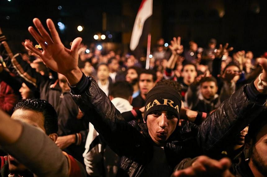 Egyptian anti-Mubarak protesters chant slogans as they gather in Abdel Moneim Riad Square in Cairo on Nov 29, 2014. -- PHOTO: AFP