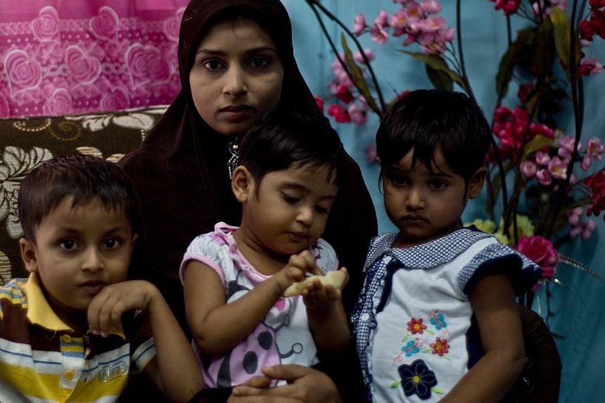 Ms Bibijan Rahimullah and her three young children endured a harrowing, month-long odyssey by sea and land to Malaysia. -- PHOTO: AFP