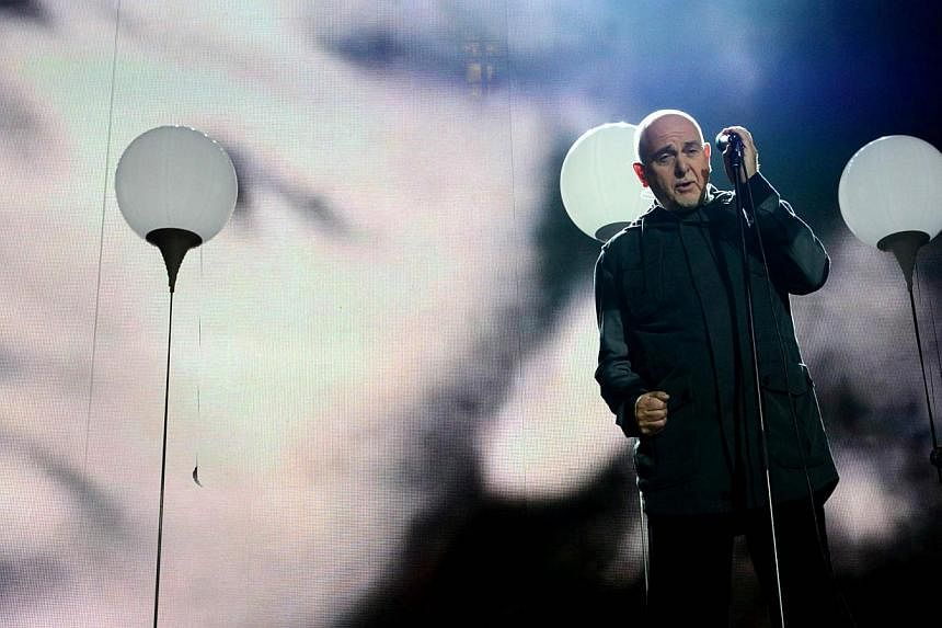 British singer Peter Gabriel performs during a Street Party organised by German governement to mark the 25th anniversary of the fall of the Berlin Wall, in front of the Brandenburg Gate on Nov 9, 2014 in Berlin. Musicians including Peter Gabriel and 