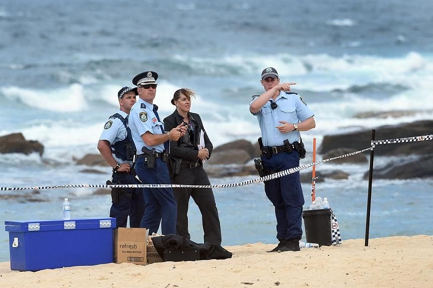Police organise a search of the sand dunes after children playing at a Sydney beach on Nov 30, 2014, stumbled across the body of a baby buried under the sand, Australian investigators said, just a week after a newborn was found crying at the bottom o