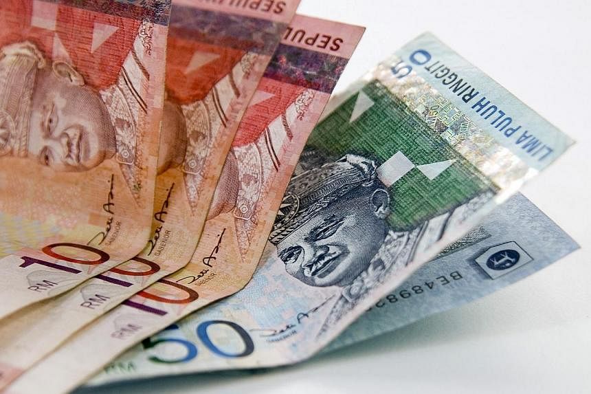 The ringgit has slumped to a 10-month low against the Singapore dollar, on concerns that a protracted slide in crude oil prices will hit oil-exporter Malaysia. -- PHOTO: BLOOMBERG