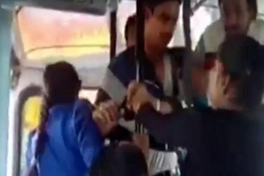 This screen grab from a video posted on YouTube shows two sisters beating up three men, who were allegedly sexually harassing them on a moving bus in the north Indian state of Haryana. -- PHOTO: SCREENSHOT FROM YOUTUBE