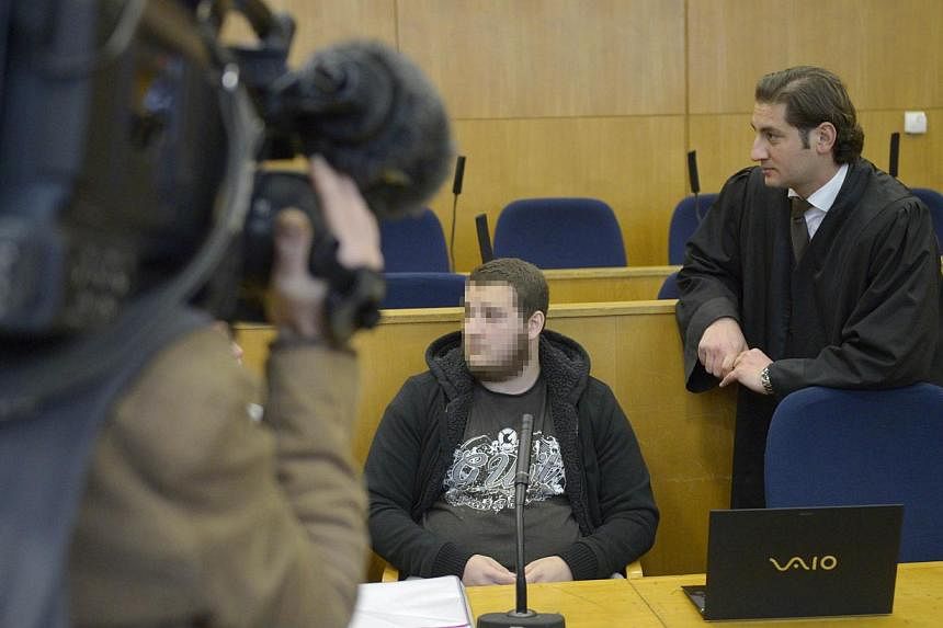 Alleged Kreshnik B (centre) next to his lawyer Mutlu Guenal (left) at the higher regional court in Frankfurt am Main, western Germany, on the opening of his trial on charges of fighting for ISIS (Islamic State in Iraq and Syria) in a photo taken on S
