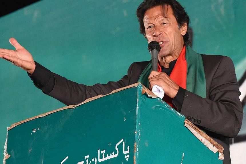 Pakistani cricketer-turned-opposition leader&nbsp;Imran Khan tells tens of thousands of supporters near parliament in Islamabad on Sunday evening that his party workers would paralyse major cities with protests starting on Dec 16. -- PHOTO: AFP