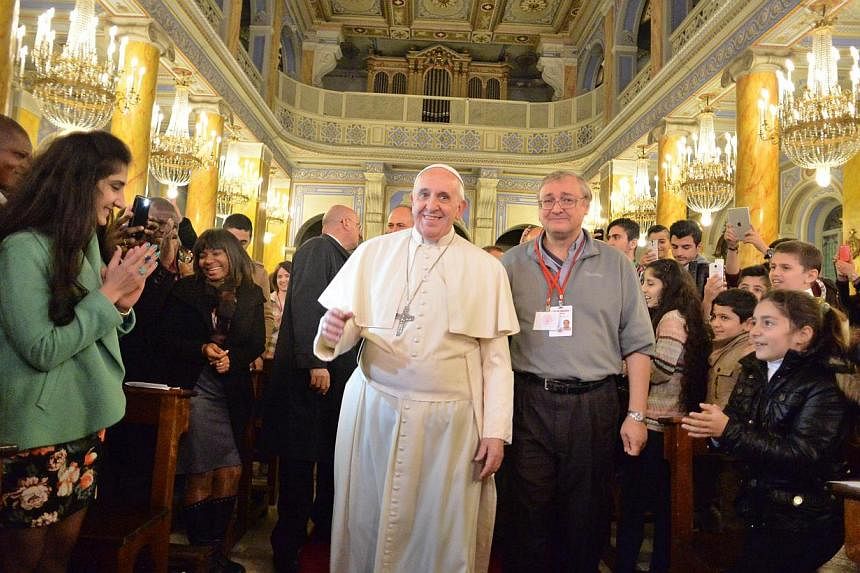 Pope Francis meeting with Iraqi refugees in Instanbul on Nov 30, 2014 as part of his three days visit in Turkey, in a handout photo released by the Vatican press officel. -- PHOTO: AFP&nbsp;