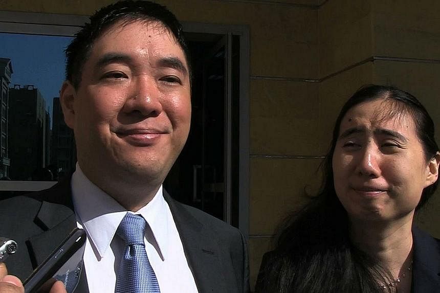 Matthew (left) and Grace Huang, a US couple charged with parental neglect leading to the death of their adopted daughter, talk to journalists after being acquitted by a Qatari appeals court on Nov 30, 2014 in Doha. Matthew and Grace Huang were arrest