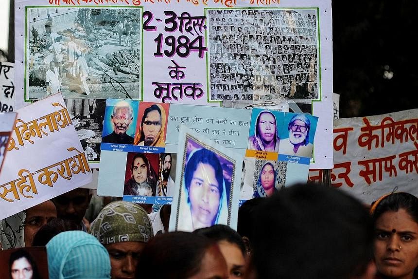 Indian victims of the Bhopal Gas disaster hold placards during a commemoration rally in Bhopal on Dec 1, 2014. -- PHOTO: AFP