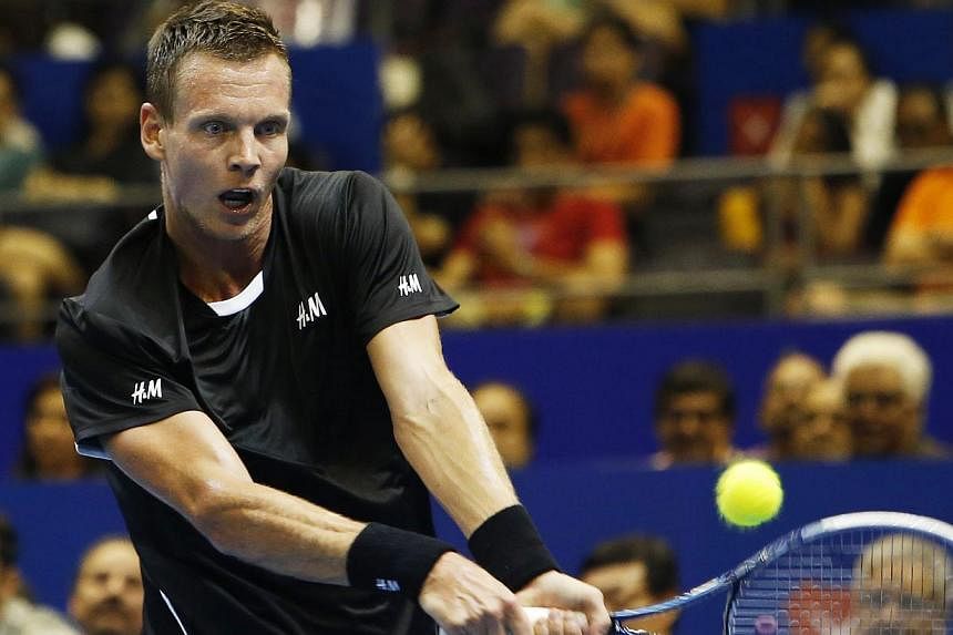 Singapore Slammers' Tomas Berdych of the Czech Republic hits a return to Manila Mavericks' Jo-Wilfried Tsonga of France during their men's singles match at the International Premier Tennis League (IPTL) in Singapore on Dec 2, 2014. -- PHOTO: REUTERS