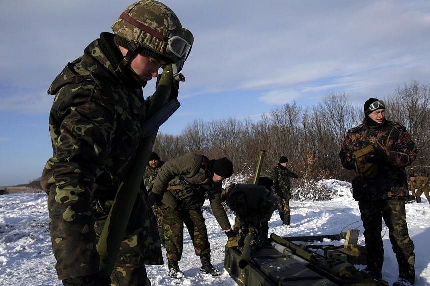 Ukrainian soldiers gather after firing missiles with man-portable air-defense systems during exercices near the city of Shchastya, north of Lugansk, on Dec 1, 2014.&nbsp;Ukraine and pro-Russian rebels have "agreed in principle" on a ceasefire in the 