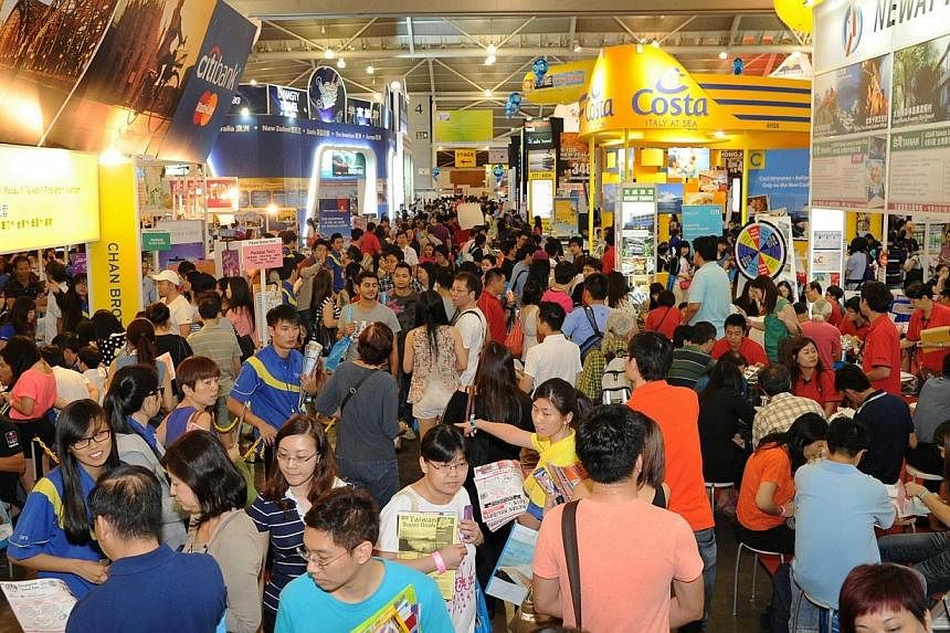Visitors thronging the various booths during a National Association of Travel Agents Singapore (Natas) Travel Fair held at the Singapore Expo. The association said it would be bringing forward its fair next year to March 6-8.&nbsp;-- PHOTO: NATAS