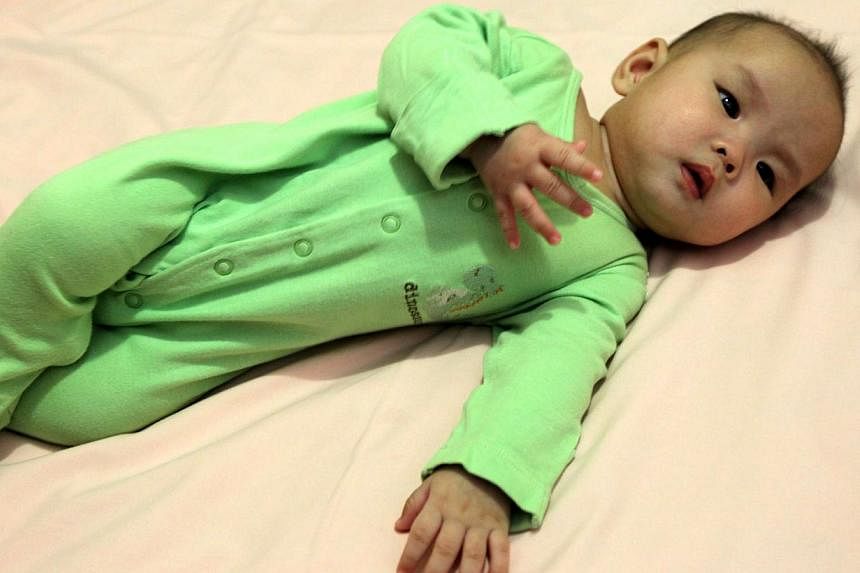 A posed photo of a baby lying on her side. More than half of infants in the United States are being placed to sleep with bedding that puts them at greater risk of sudden infant death syndrome (SIDS), researchers warned in a report on Monday. -- PHOTO