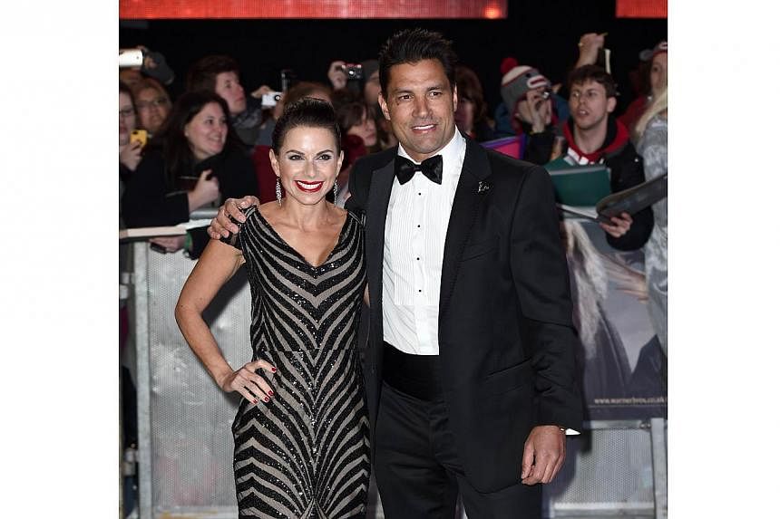 Australian-New Zealand actor Manu Bennet and his wife, Karin Horen, posing for pictures on the red carpet upon arrival for the world premiere of The Hobbit: The Battle Of The Five Armies in central London on Dec 1, 2014. -- PHOTO: AFP
