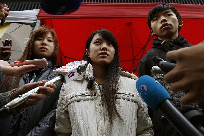 (From left) Students Isabella Lo, Prince Wong and Joshua Wong speak to journalists during their hunger strike outside government headquarters in Hong Kong on Dec 2, 2014. -- PHOTO: REUTERS