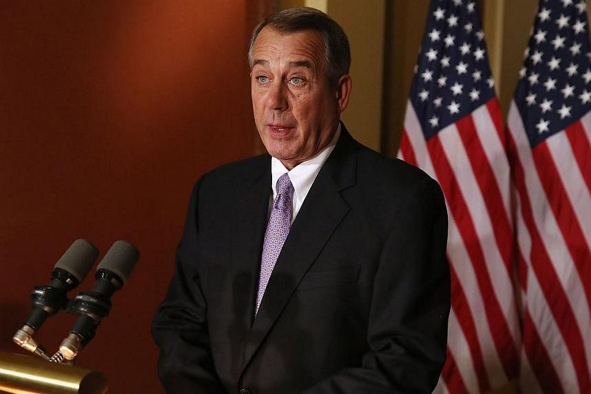 US House of Representatives Speaker John Boehner's government spending bill will avoid a shutdown fight but allows Republicans to strike back at President Barack Obama's immigration order. -- PHOTO: AFP