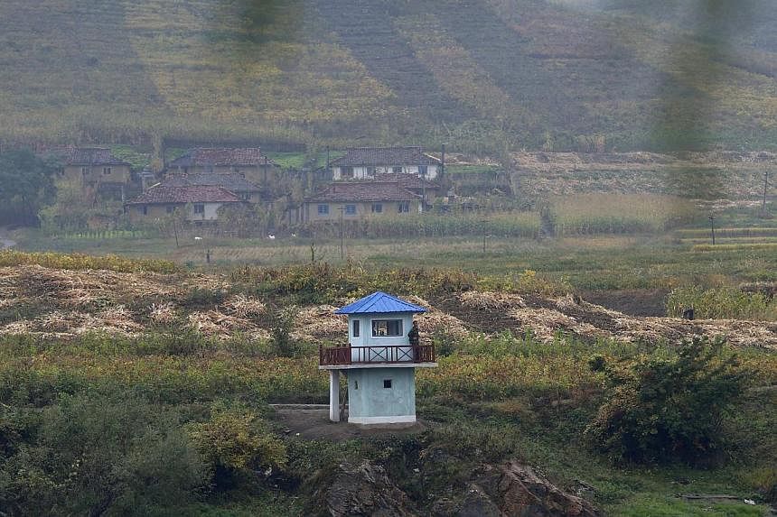 North Korean soldiers stand guard at a sentry on the Yalu River near the North Korean city of Hyesan, Ryanggang province, opposite the Chinese border city of Linjiang. A retired People's Liberation Army general said China will not step in to save the