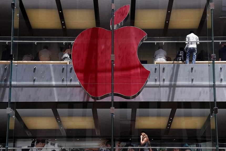 The Apple logo on display at the Sydney Apple Store is illuminated in red to mark World AIDS Day, in Sydney on Monday. Apple stores across the world will display similar colored logos, with the Sydney store being the first. World AIDS Day is observed