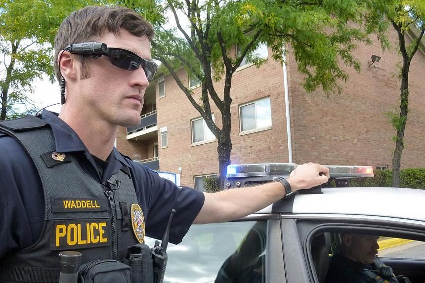 Police Officer Aaron Waddell showing on Sept 17, 2014, how the police department in Laurel, Maryland, has been using body-cameras during patrols for nearly two years. -- PHOTO: AFP