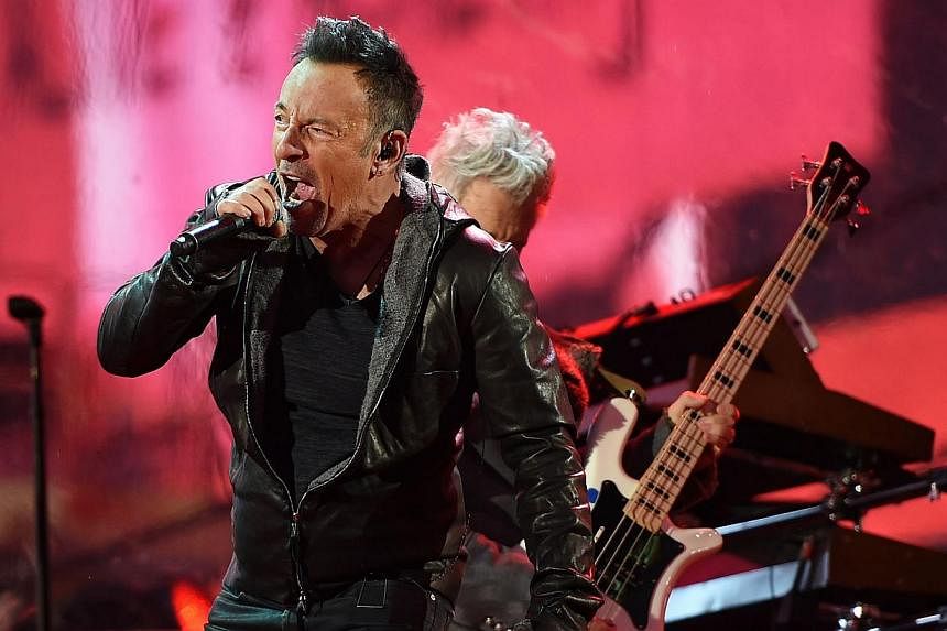 Bruce Springsteen performs during the World AIDS Day (RED) concert in Times Square in New York on Dec 1, 2014. RED is an organization that aims to prevent HIV transmission from mother to child. -- PHOTO: AFP