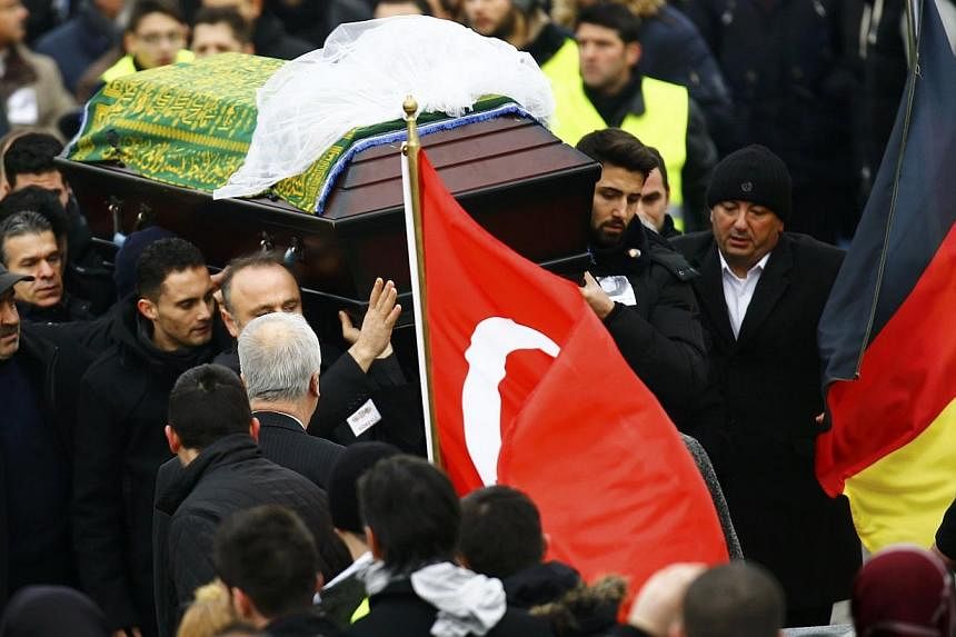 People carry a coffin holding the body of late student Tugce Albayrak during a memorial service in Waechtersbach, on Dec 3, 2014.&nbsp;Germans flocked to the funeral on Wednesday of a young woman of Turkish origin who has become a symbol of civic cou