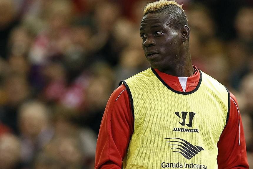 Liverpool's Mario Balotelli warms up at Anfield in Liverpool, northern England, Oct 28, 2014. Balotelli apologised on Tuesday for posting a message on Instagram that appeared to contain racist and anti-Semitic references and which has sparked a Footb