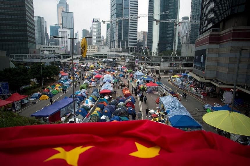 A folded Chinese flag is seen at the pro-democracy movement's main protest site in the Admiralty district of Hong Kong on Dec 2, 2014. British MPs urged the government to take a tougher line with China in an emergency House of Commons debate on Tuesd