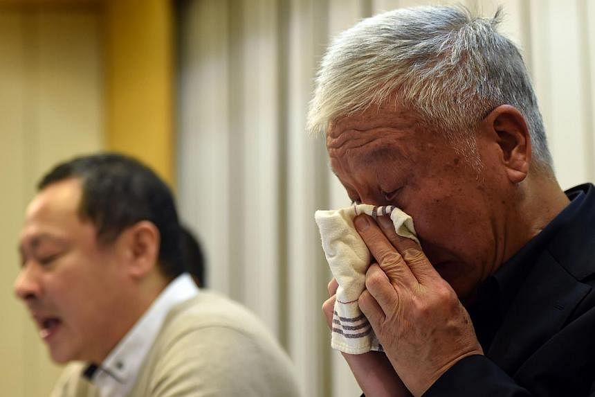 Pro-democracy activists Benny Tai (left) attends a press conference while Chu Yiu-ming (right) reacts in Hong Kong on Dec 2, 2014. The three original founders of Hong Kong's pro-democracy Occupy movement tearfully announced they would "surrender" by 