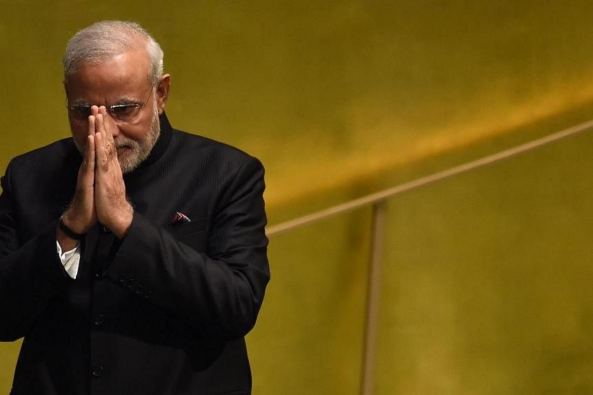 Indian Prime Minister Narendra Modi is under growing pressure to sack a minister over a tirade she made against religious minorities, as his outraged opponents disrupted parliament for a second day on Wednesday. -- PHOTO: AFP