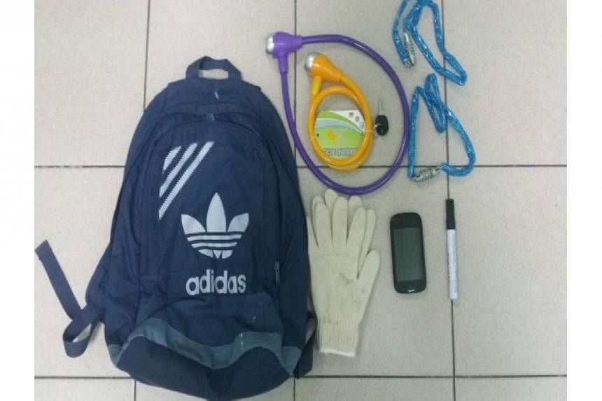 Mobile phone, pair of gloves, marker pen, four bicycle locks seized after arrest on Tuesday of 42-year-old man who is suspected of harassing debtors for a loanshark syndicate.&nbsp;-- PHOTO:&nbsp;SINGAPORE POLICE FORCE