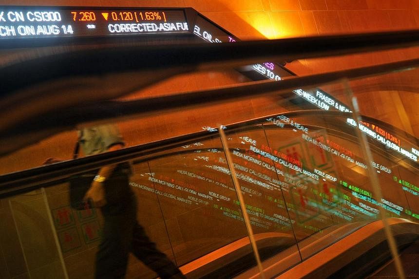 Stock tickers along the wall at the Singapore Exchange (SGX). The software error that delayed the opening on Wednesday of the local stock market was caused by "programming changes performed over the weekend," SGX says. -- PHOTO: ST FILE&nbsp;
