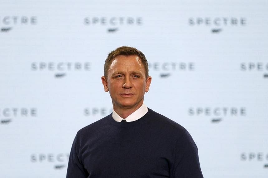 Actor Daniel Craig poses on stage during an event to mark the start of production for the new James Bond film Spectre, at Pinewood Studios in Iver Heath, southern England&nbsp;on Dec 4, 2014. -- PHOTO: REUTERS