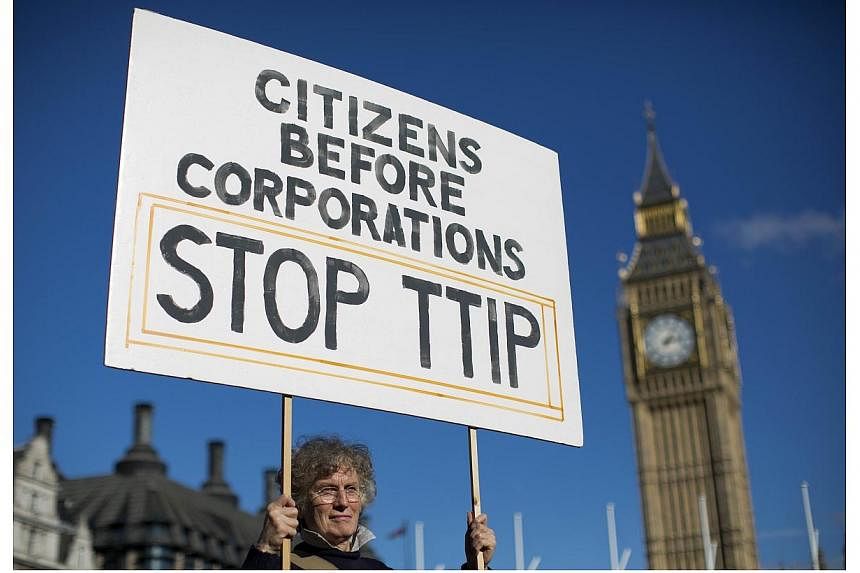 A woman demonstrates in central London on Oct 11, 2014, against the proposed Transatlantic Trade and Investment Partnership (TTIP).&nbsp;Opponents to a controversial trade pact between the EU and the United States passed a key threshold on Thursday s