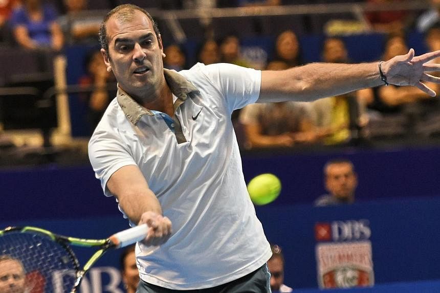 France's Cedric Pioline of India Aces plays against Australia's Mark Philippoussis of the Manila Mavericks during their men's singles at the International Premier Tennis League (IPTL) competition in Singapore on Dec 4, 2014. -- PHOTO: AFP
