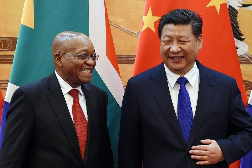 South African President Jacob Zuma (left) and Chinese President Xi Jinping share a laugh as they attend a signing ceremony at the Great Hall of the People in Beijing on Dec 4, 2014.&nbsp;-- PHOTO: REUTERS