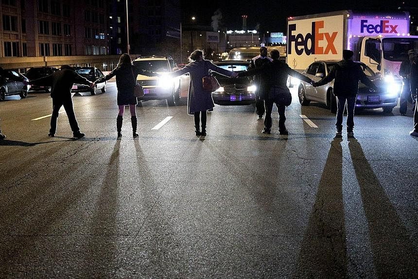 Demonstrators block traffic on Highway I-395 during a protest against a New York grand jury decision in Washington, DC. The grand jury decided not to indict police officer Daniel Pantaleo in the death of an unarmed black man, Eric Garner, after putti