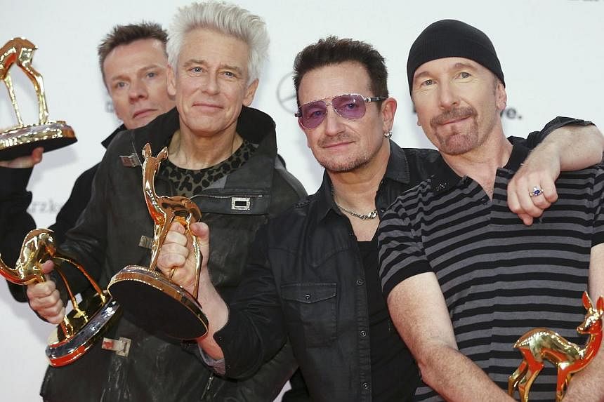 U2 pose with their Music International trophies during the Bambi 2014 media awards ceremony in Berlin Nov 13, 2014. The Irish band,&nbsp;whose last tour in 2009-2011 was the highest-grossing ever, on Wednesday announced concerts in 2015 across North 